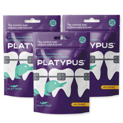 Close-up of Platypus orthodontic flossers under arch wire design