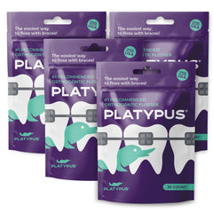 Platypus orthodontic flossers under arch wire between braces