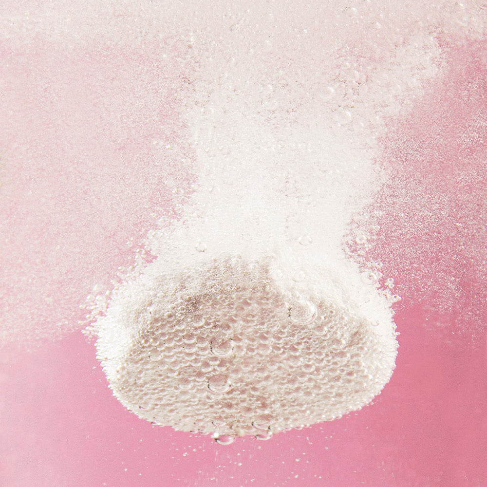 Water glass with fizz and berry aroma from Plink.