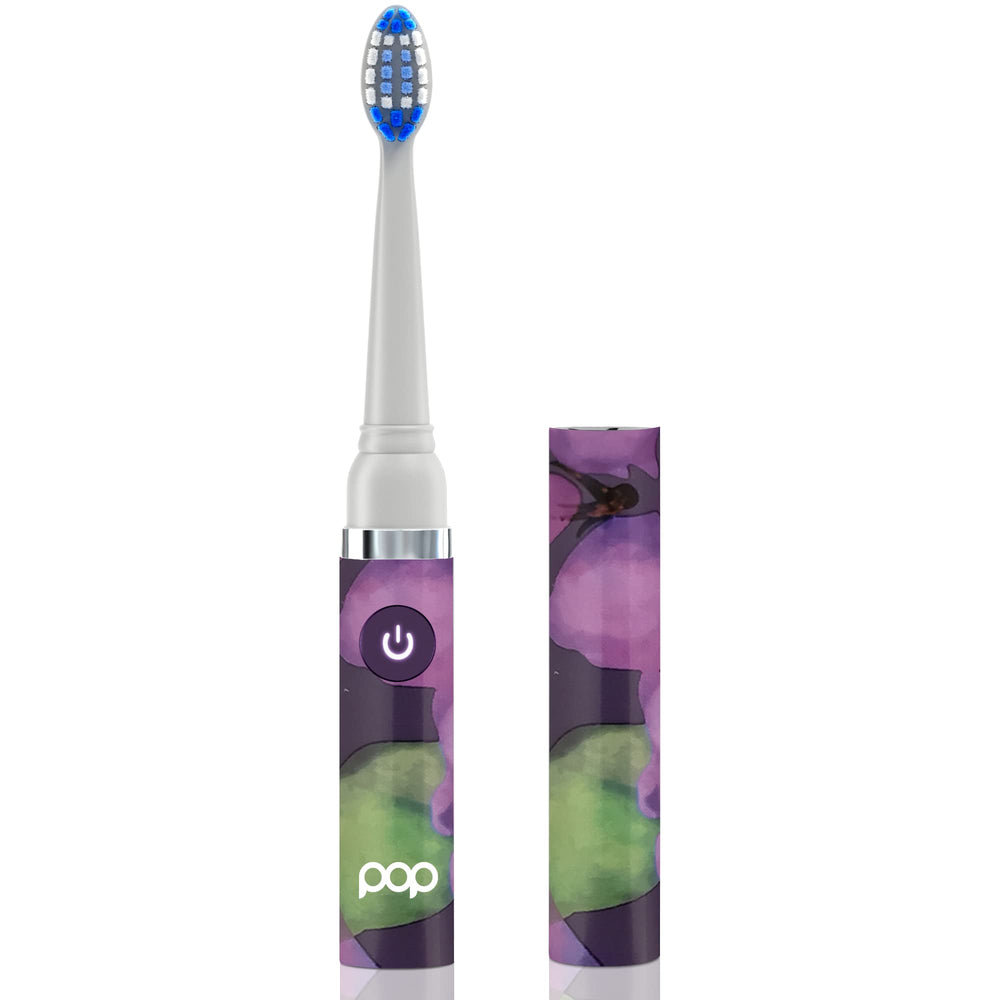 Travel toothbrush with purple artwork and snap on cap