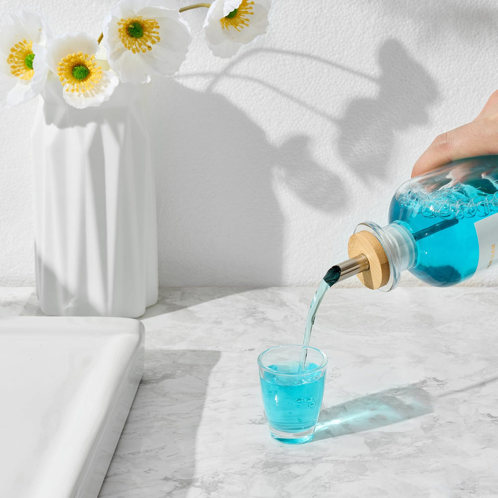 Stainless steel pour spout attached to mouthwash bottle