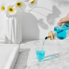 Stainless steel pour spout attached to mouthwash bottle