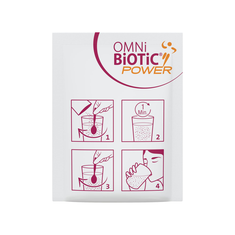Probiotic powder and glass of water on a gym towel demonstrating daily usage