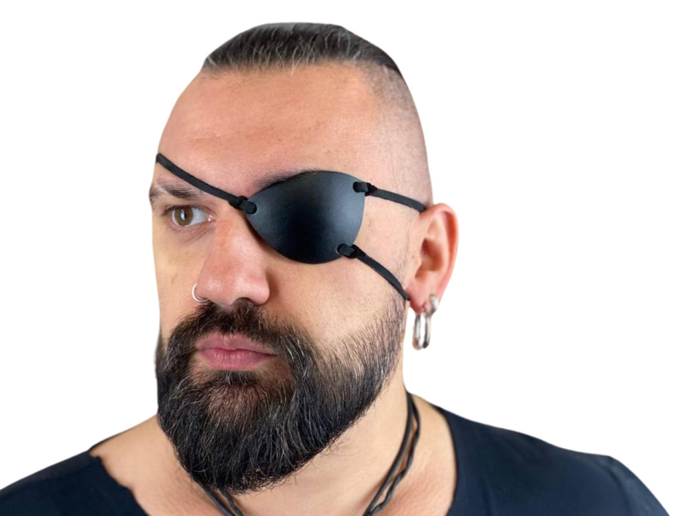 Left black premium leather eye patch with foam padding along inner edge