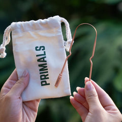 Packaging including cloth pouch for PRIMALS tongue scraper