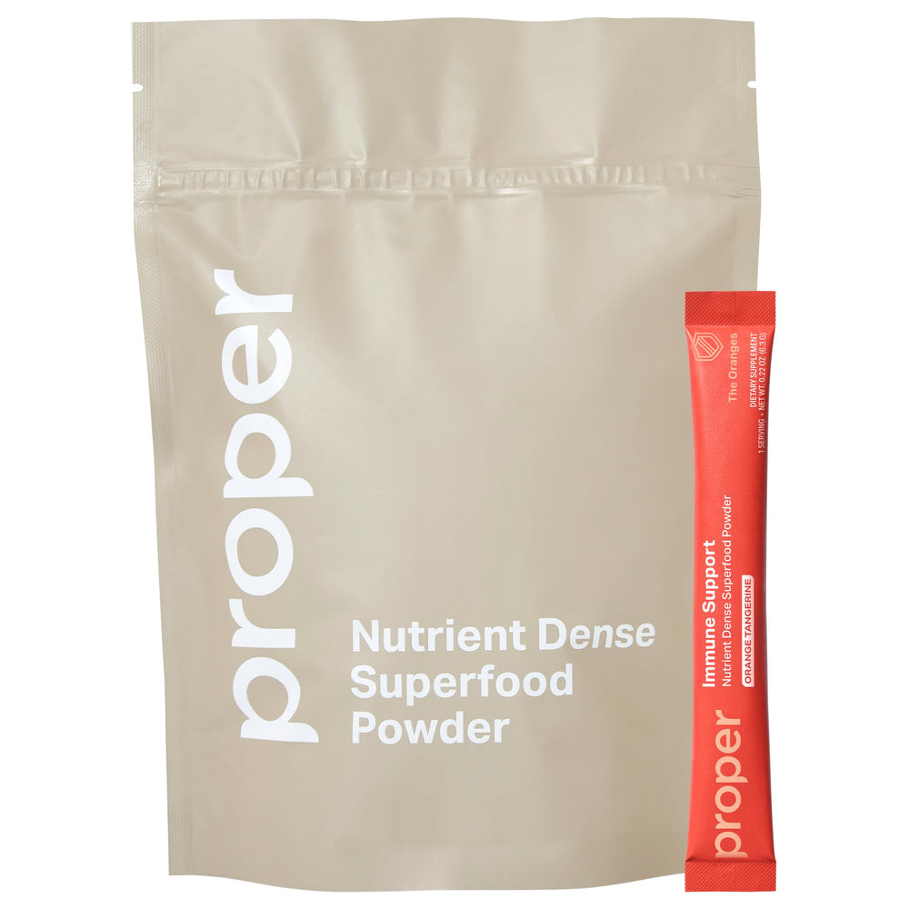 Bottle of Proper The Oranges Immune Support Supplement with scoop