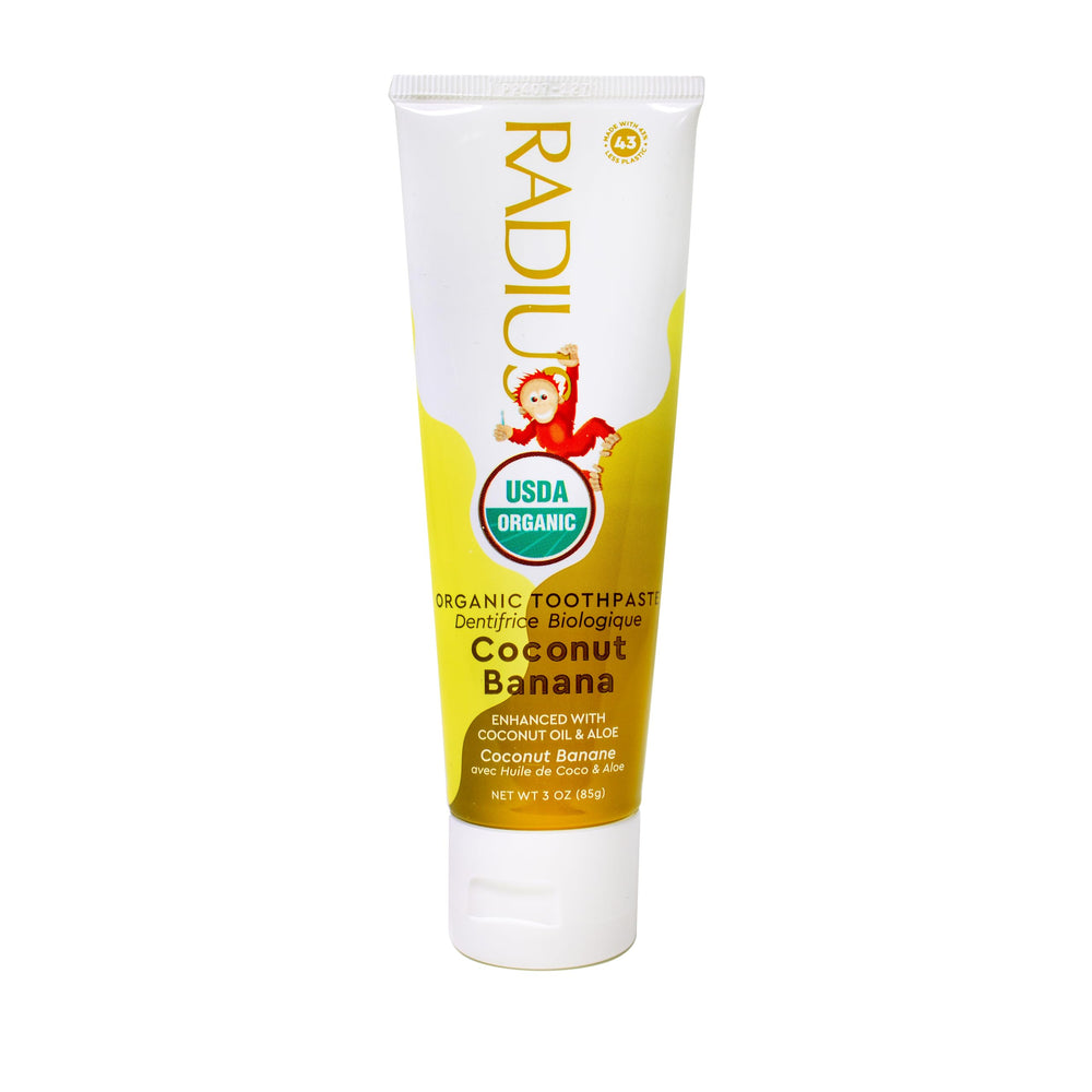 Toothpaste tube displaying Coconut Banana flavor for kids