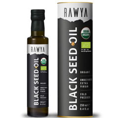 RAWYA Black Seed Oil being drizzled over a salad with bottle in background