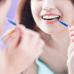 Using an interdental brush to clean between teeth