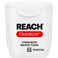 Close-up of cinnamon-flavored floss between teeth