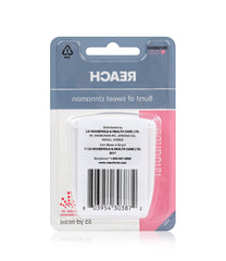 Flossing between teeth with Reach Cleanburst Cinnamon waxed floss
