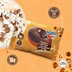 REDEFINE protein donut texture close-up emphasizes chewy crumb and cookie-dough bits.