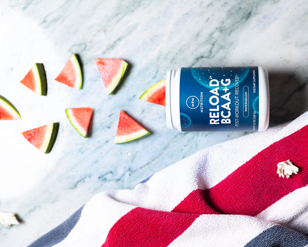 Glass of water with mixed Reload BCAA+G Watermelon flavor