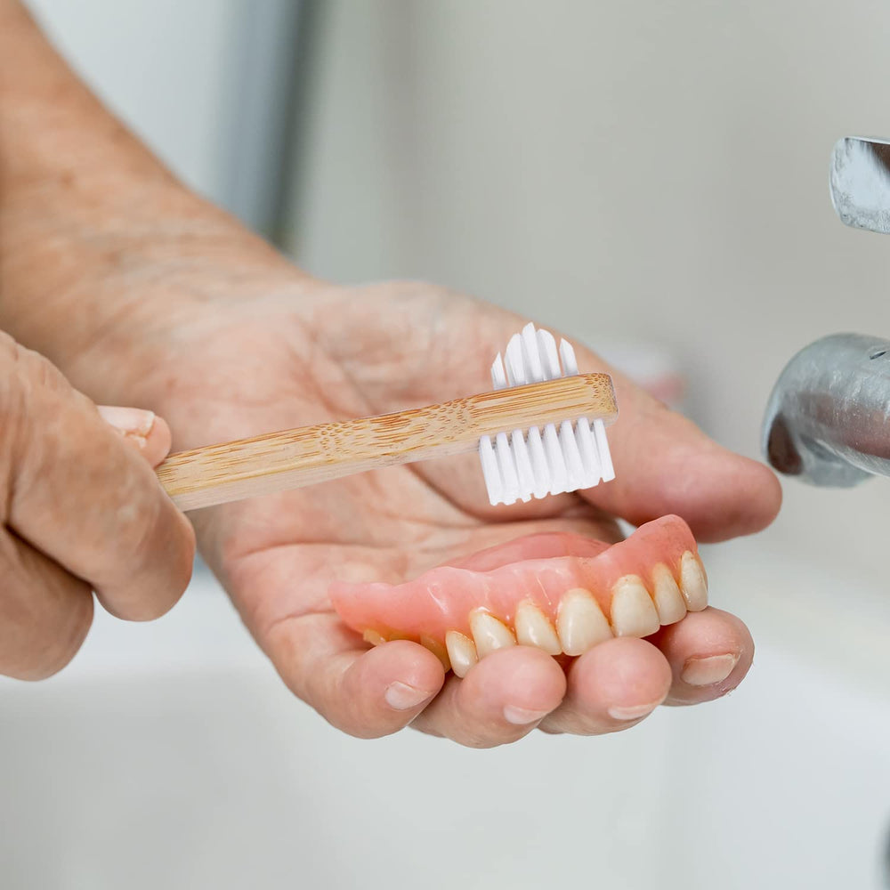 Illustration of dentures, retainers and aligners being cleaned with kit