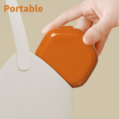 Compact travel-friendly orange denture case