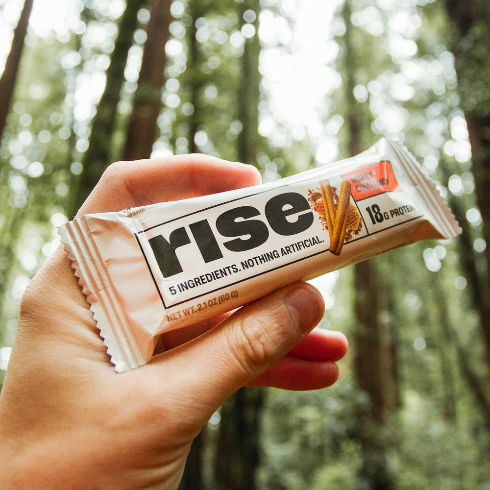 Rise Whey Bars Honey Cinnamon with cup of coffee on a breakfast table