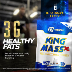 Scoop pouring King Mass XL into a shaker for a post-workout shake