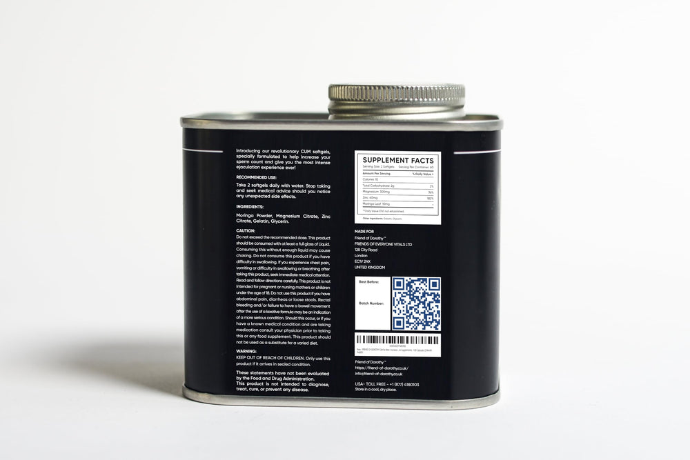 Open bottle with capsules spilled on a white surface