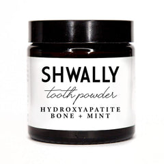 Shwally Tooth Powder bottle and label on a white background