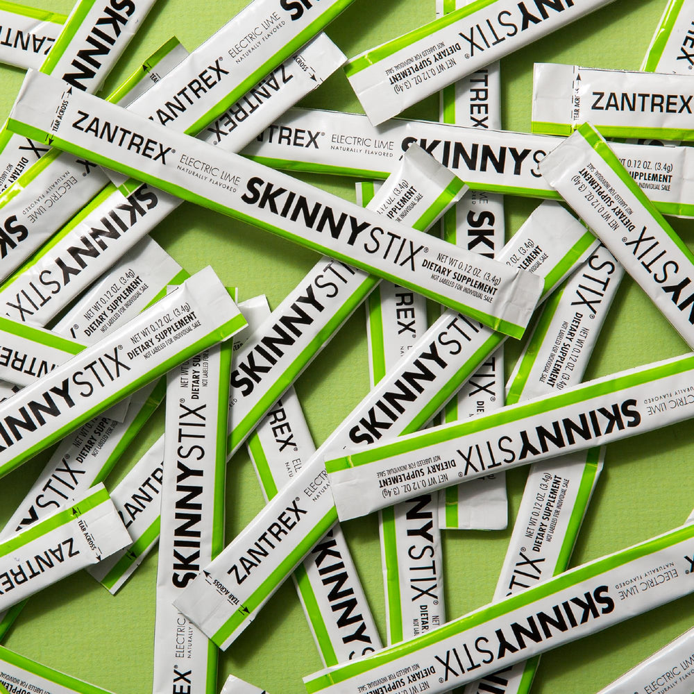 Lifestyle image showing on-the-go use with SkinnyStix Lime packets