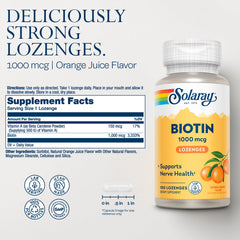 Orange-flavored biotin lozenges on a white surface