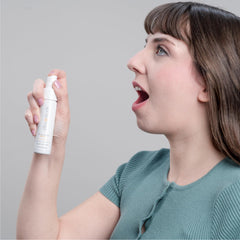 Family-friendly image showing adults and kids using the spray