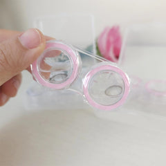 Storage box containing two cases with tweezers and lens holder