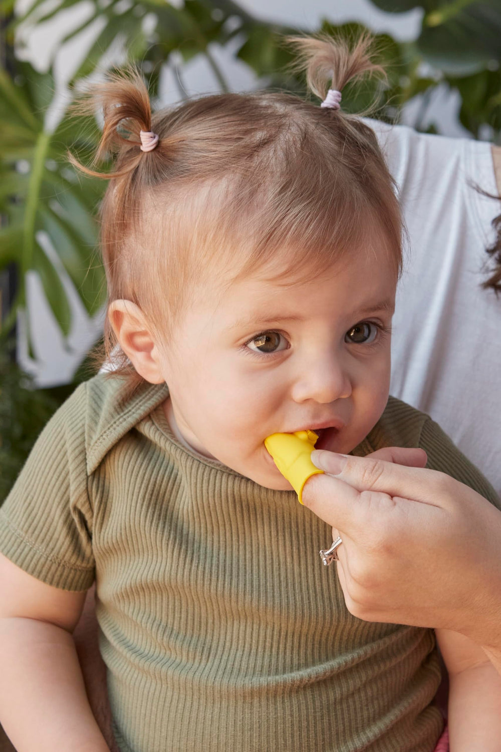 Built-in bite block protecting parents' fingers