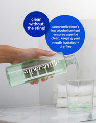 Pouring Supersmile Oral Rinse into a cup