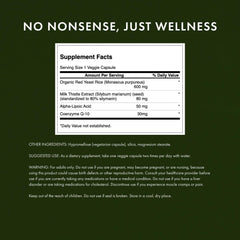 Two veggie capsules poured from Swanson bottle on white background