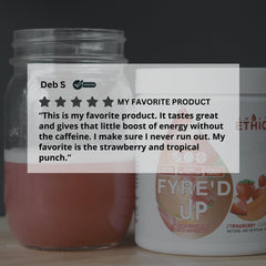 Scoop of FYRE’D UP powder next to a measuring cup