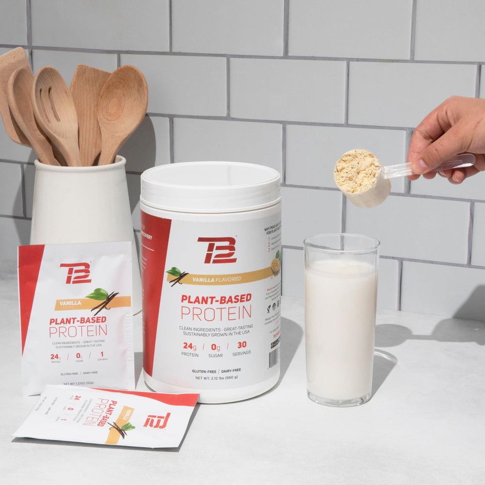 TB12 vanilla plant-based protein powder bottle with scoop