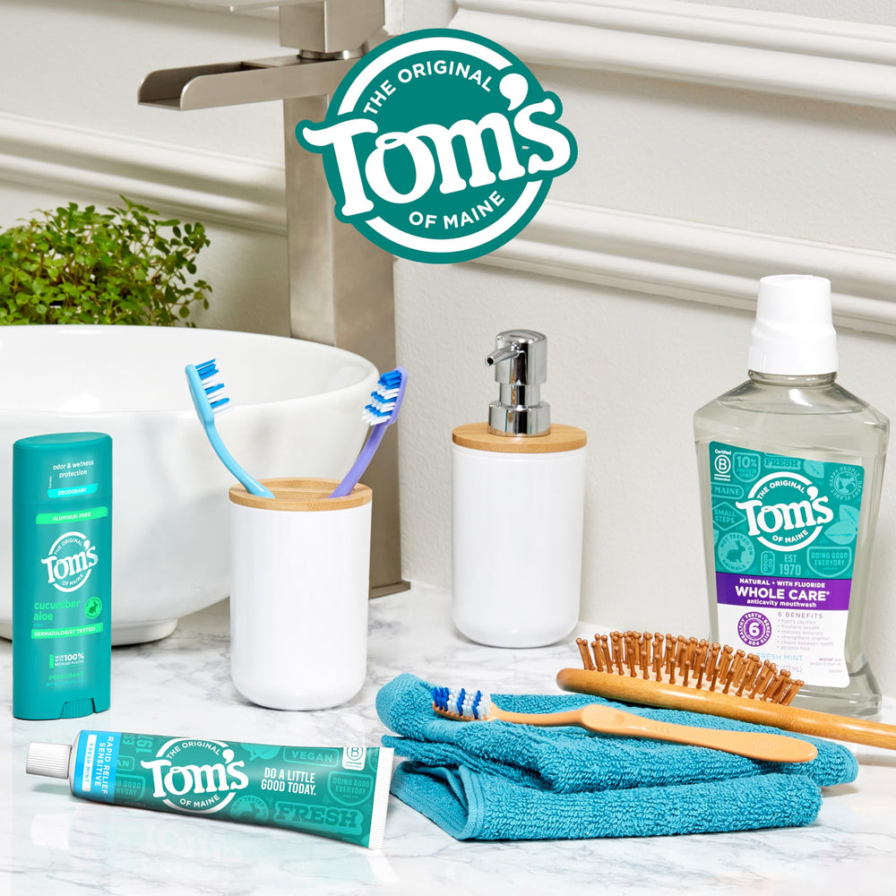 Tom's of Maine Rapid Relief toothpaste with Fresh Mint and mint garnish background