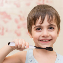 Toothbrush with power tip and angled bristles for deep cleaning