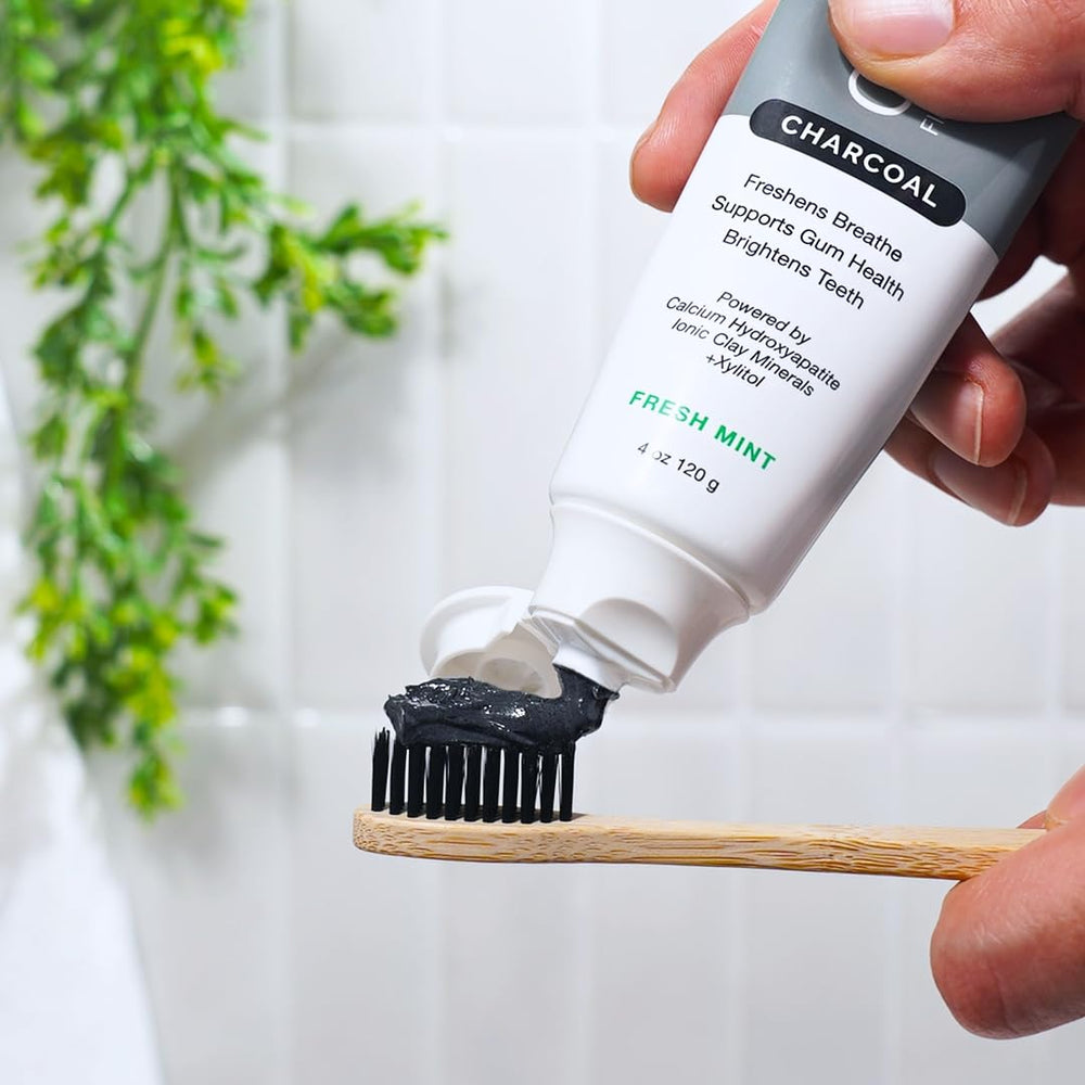 Open 4 oz toothpaste tube with charcoal paste