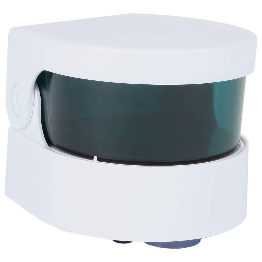 Portable vibrating denture cleaner in a bathroom setting