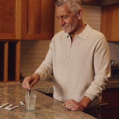 On-the-go use: stirring Tru Niagen sticks into a drink
