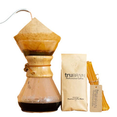 Scoop of powder beside a cup of coffee