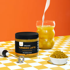 Turmeric latte powder added to coffee for a creamy beverage