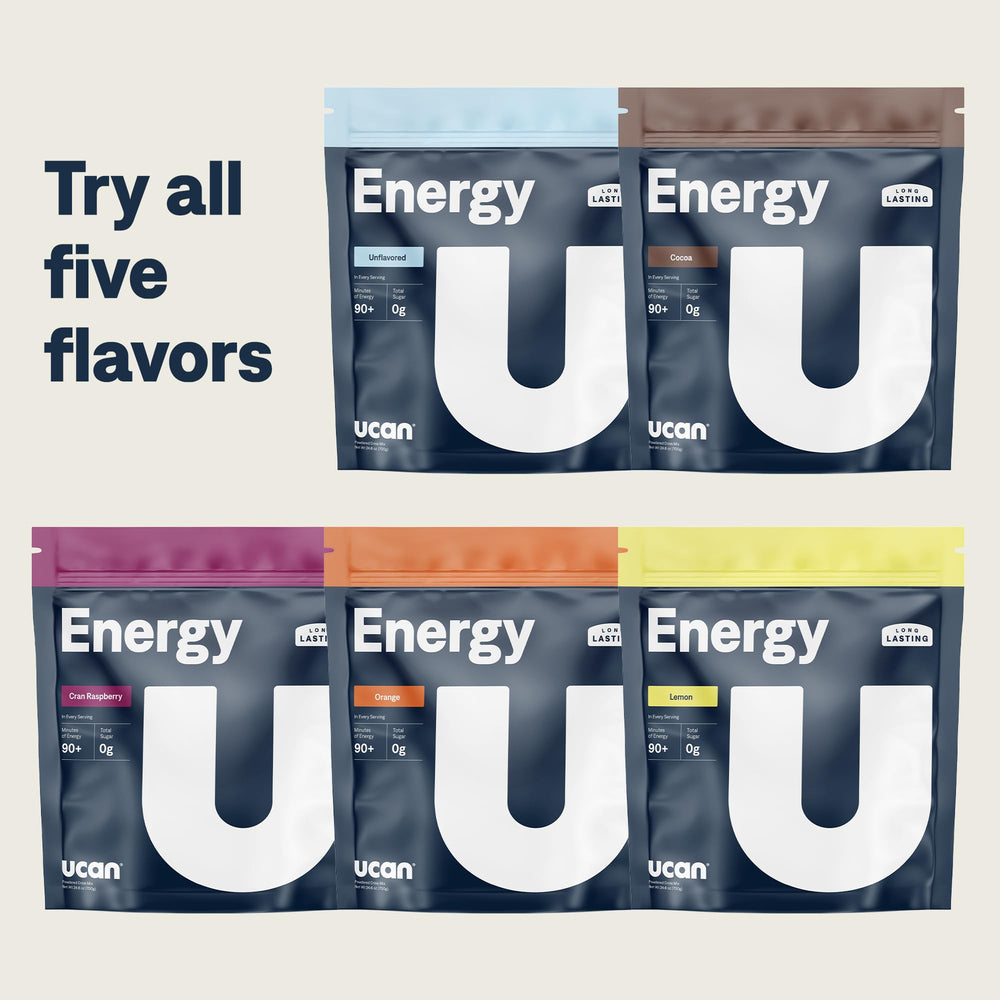UCAN Energy Powder Tropical Orange scoop beside athletic gear for sustained endurance