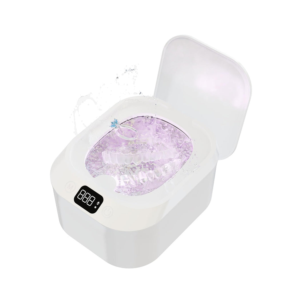 White Ultrasonic Retainer Cleaner with transparent lid on bathroom counter