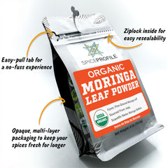 Vibrant green moringa powder on white