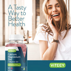 A person holding a bottle of Viteey Raspberry Calcium Magnesium Zinc Gummies