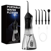 Portable water dental flosser held in hand showing compact design