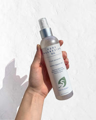 Close-up of magnesium beauty oil bottle with subtle floral fragrance