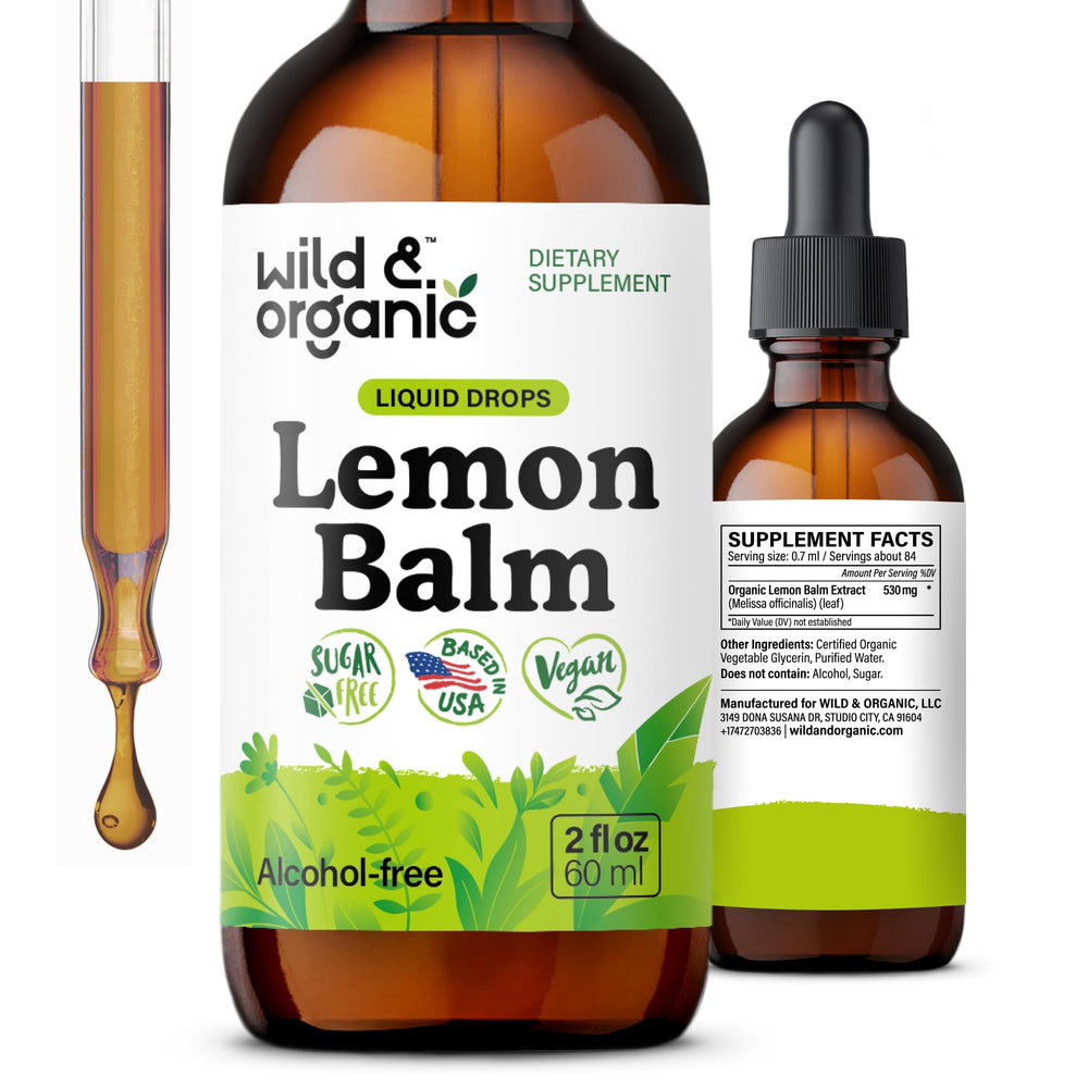 Bottle of Wild & Organic Lemon Balm Drops with lemon balm leaves and lemons