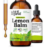 Bottle of Wild & Organic Lemon Balm Drops with lemon balm leaves and lemons