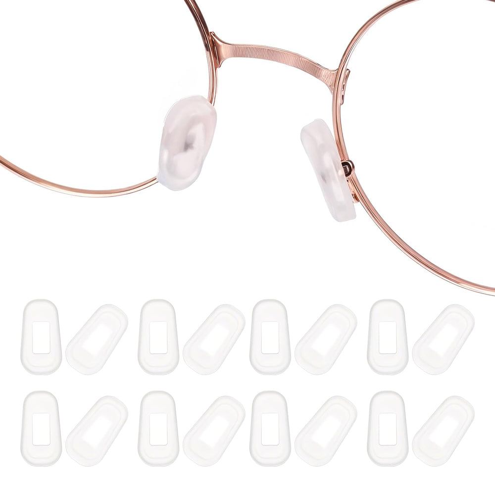 Transparent white silicone eyeglass nose pads displayed on a white background
