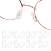 Transparent white silicone eyeglass nose pads displayed on a white background