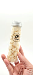 Close-up of YouClean toothpaste tablets inside the glass jar